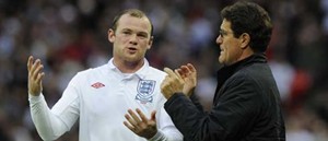 Fabio Capello discusses tactics with Wayne Rooney.